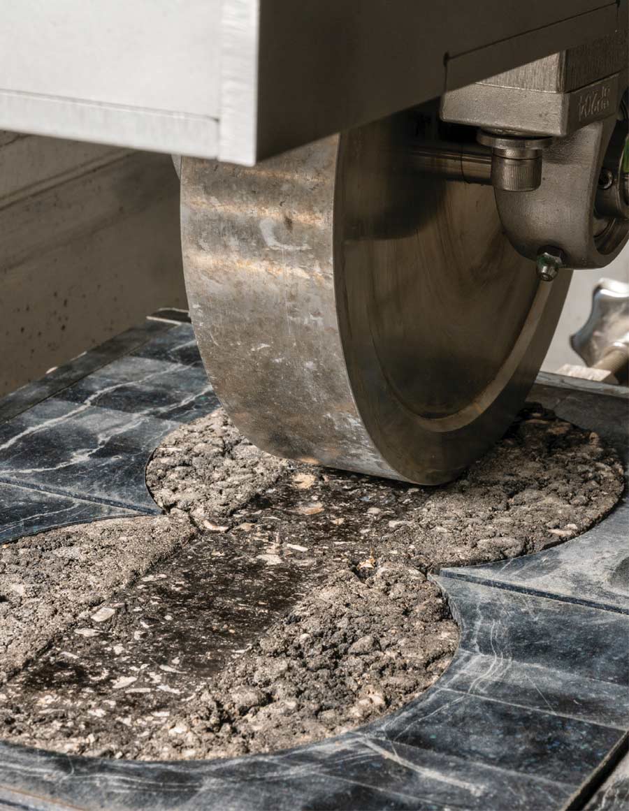 Civil engineers test the durability of recycled plastic and asphalt composite material for road construction.