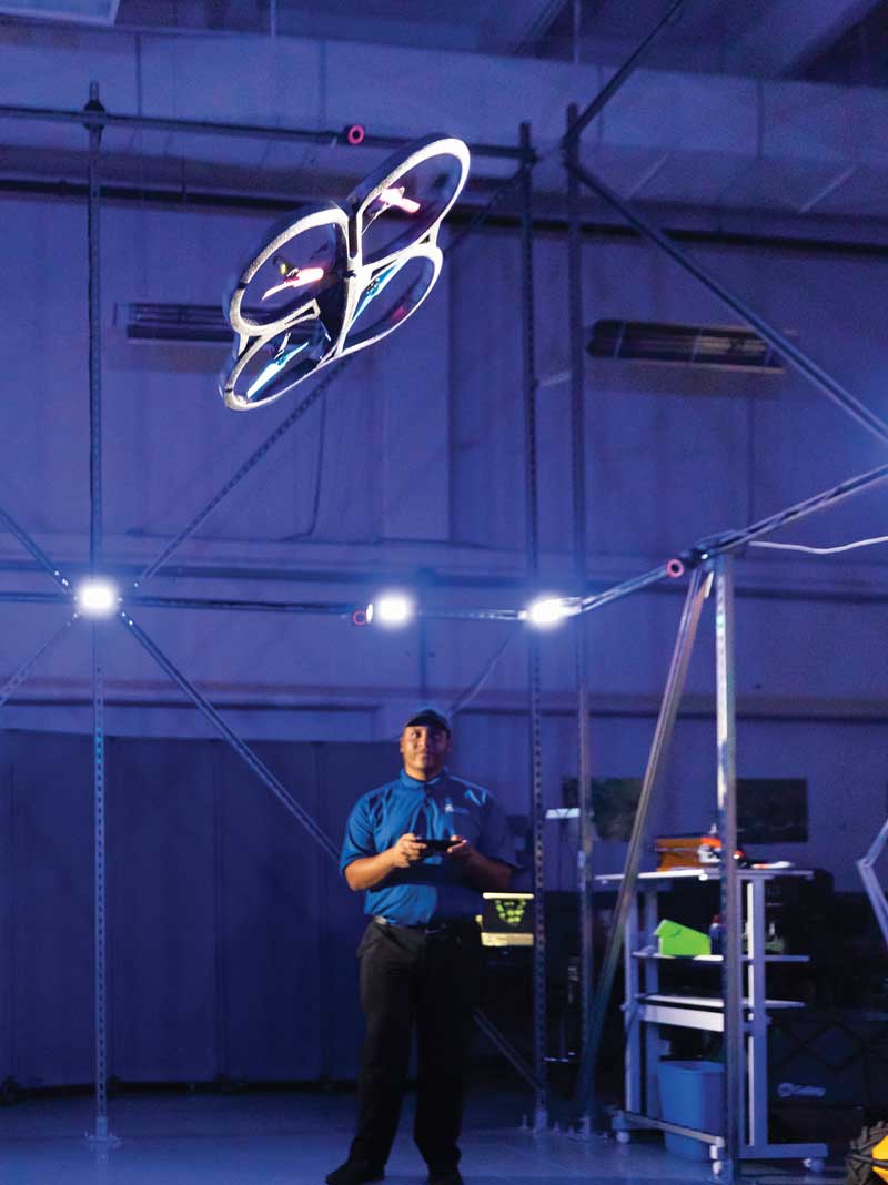A drone being flown indoors by a researcher.