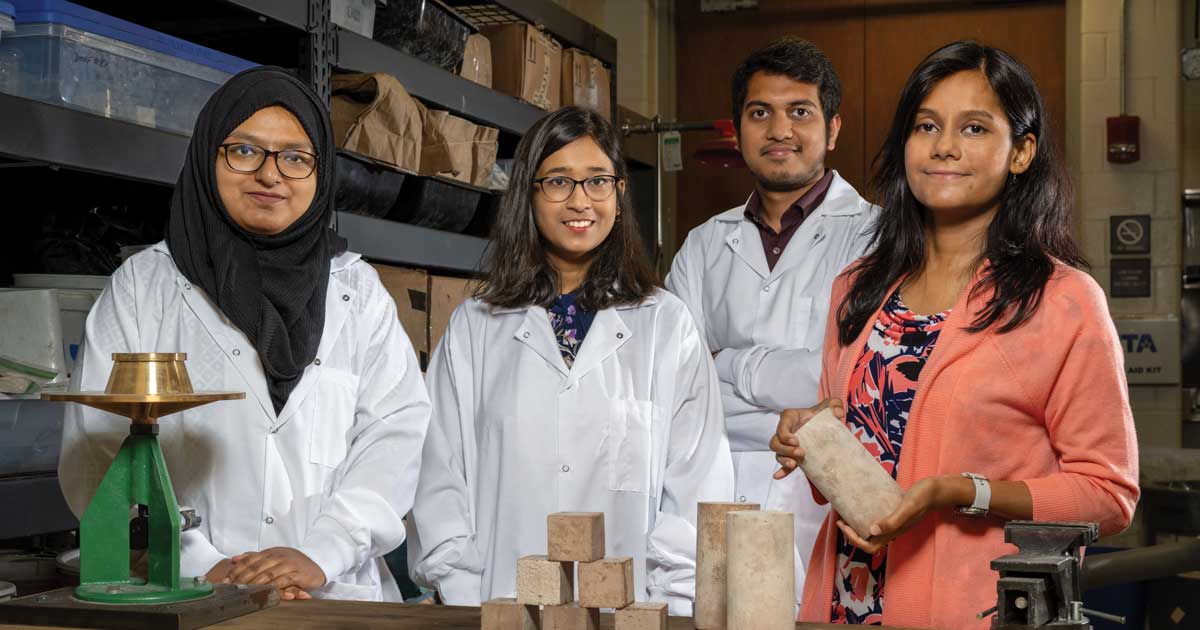Warda Ashraf and three students in a civil engineering lab