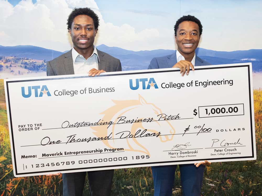 Student winners of the MavPitch competition hold their giant check.