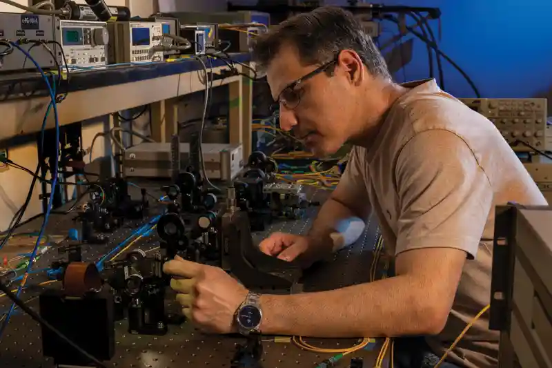 A UTA researcher works in the lab on quantum research.