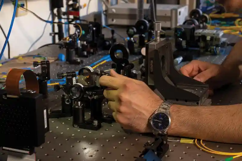 A UTA researcher works in the lab on quantum research.