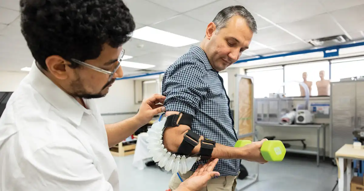 Man is being fitted with a robotic assistance device